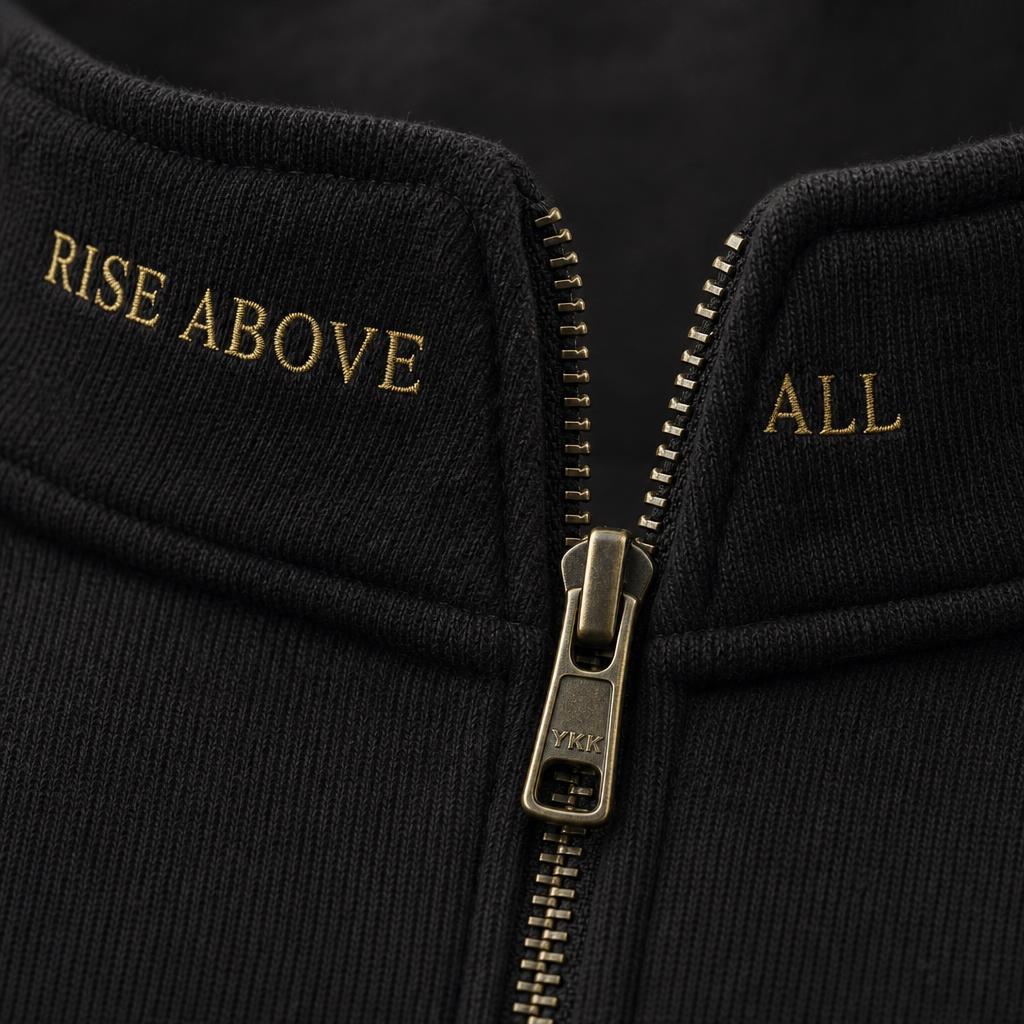 Gold RISE ABOVE ALL collar embroidery detail